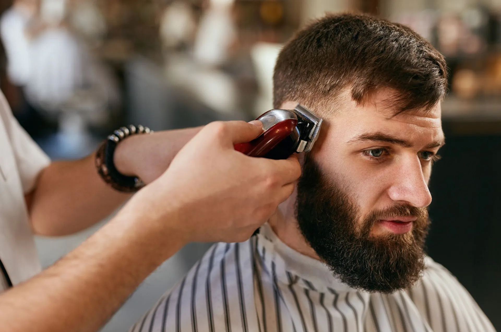 Barber finishing a clean fade at Vintage Barbershop and Salon